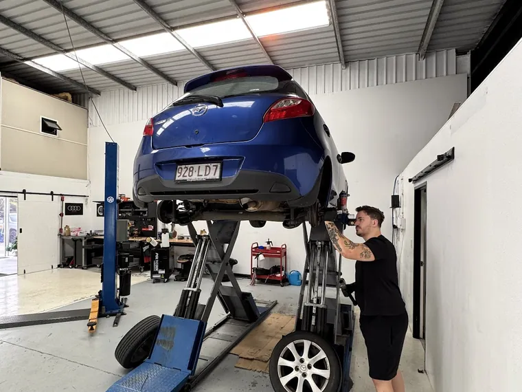 Car raised on the hoist for a wheel alignment at Checkpoint Motors Banyo
